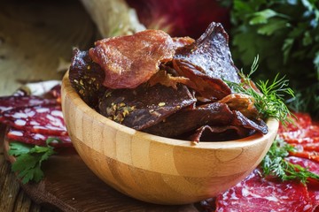 Uncooked jerked sausages meat chips, from a beef, pork and chick