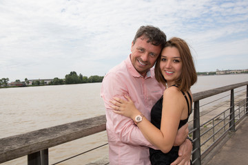 Fototapeta na wymiar Cheerful and lovely couple outdoor by the river