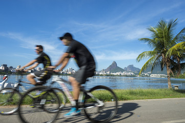 Athletic Brazilians cycling in motion blur at Lagoa Rodrigo de Freitas lagoon, Rio de Janeiro, Brazil