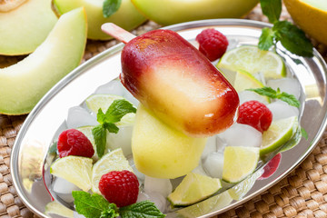 Melon lime raspberries sorbet ice cream popsicles.