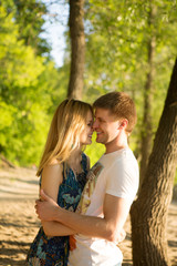 Fototapeta premium the young loving couple embraces outdoors in summer day