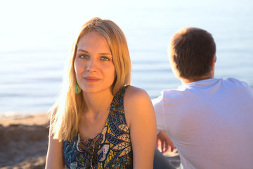 young loving couple on the beach in summer day