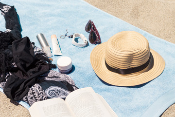 Beauty products for make a relaxed day on the beach with a book
