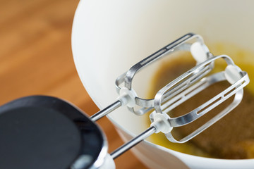 Whisking dough with mixer in a bowl