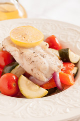 Fish Provencal a seafood dish of roasted mediterranean vegetables and white fish 