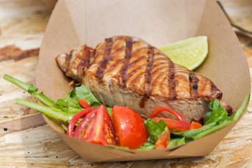 street food tuna steak served with vegetables closeup