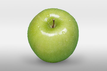 Green apple with water drops on white background. Front view.