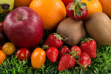 Assortment of exotic fruits on wooden table on green background