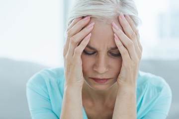 Close-up of senior woman suffering headache