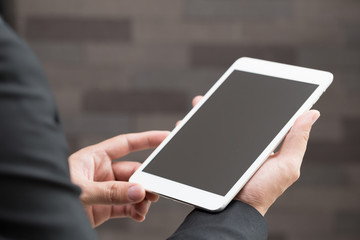 Closeup of businessman holding digital tablet with blank Screen