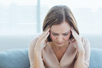 Tensed woman sitting at home