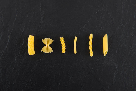 Pasta uncooked on black late background 
