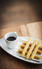 churros and chocolate spanish donuts with sauce breakfast snack