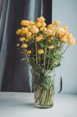 Fresh bunch of yellow summer flowers in glass vase on a white windowsill background. Cozy home rustic style decor, still life concept. Village ,  gardening. Tonal correction filter effect