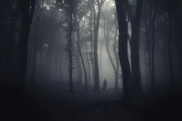 Deurstickers spooky figure in dark forest © andreiuc88
