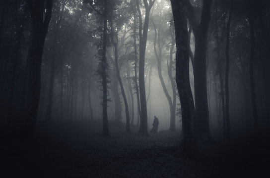 spooky figure in dark forest
