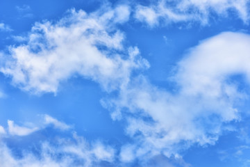 Puffy clouds on blue sky background