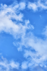 Puffy clouds on blue sky background