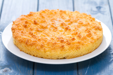 coconut tarte on white plate in blue wooden background