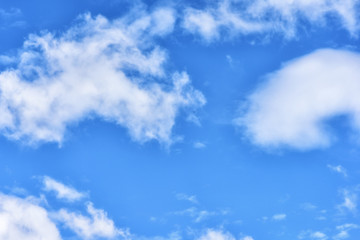 Puffy clouds on blue sky background