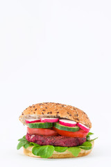 Vegan beetroot burger with lamb's lettuce, tomato, cucumber and radish isolated on white background

