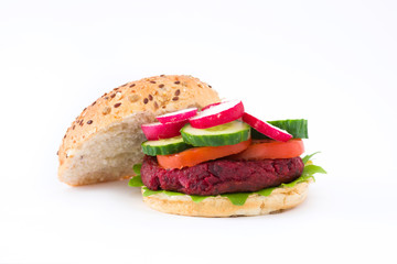 Vegan beetroot burger with lamb's lettuce, tomato, cucumber and radish isolated on white background

