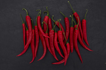 hot red peppers on black slate background