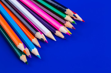 Colorful pencils isolated on a blue background