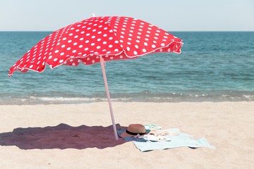 Umbrella with beach gear and beauty woman things