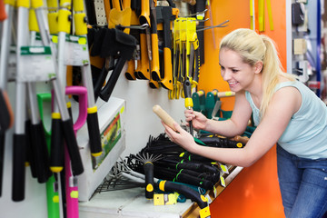 Woman in shop with gardening tools