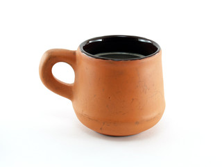 close up single brown orange baked clay coffee cup isolated on white background, black coffee in vintage design ceramic cup