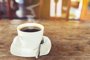 A cup of hot coffee on table.
