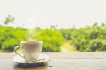 A cup of hot coffee on table.