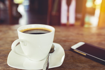 A cup of hot coffee on table.
