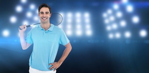 Portrait of badminton player standing with hand on hip