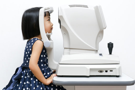 Asian Little Chinese Girl Doing Eyes Examination Through Auto re