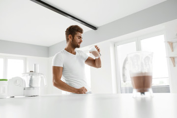 Healthy Eating. Muscular Man Drinking Sports Shake Drink Indoors