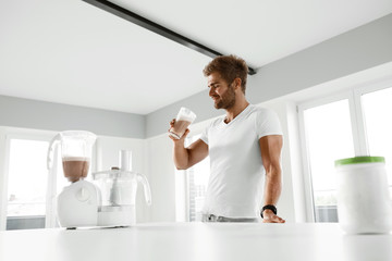 Nutrition Supplements. Man Drinking Protein Shake Before Workout