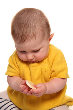 Baby girl eating finger food