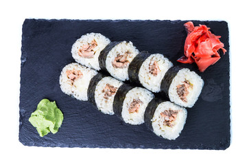 Sushi Set and sushi rolls on black stone slate. Restaurant food concept.