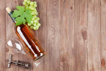 Bunch of grapes, white wine bottle and corkscrew
