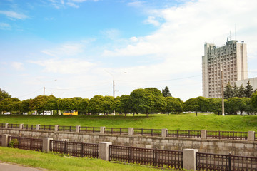 City embankment, green trees, sky, buildings, beautiful landscape