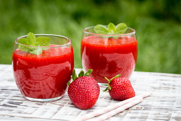 strawberry smoothie on a light wooden background