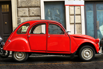 Red retro car on the street in Rome