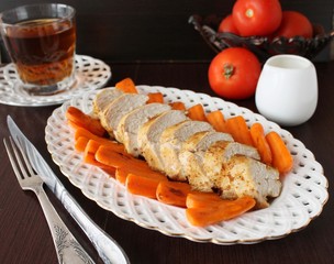 Roast chicken fillet with baby carrots.
