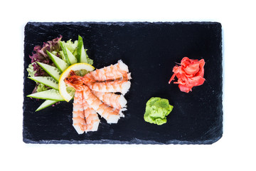 Sushi Set and sushi rolls on black stone slate. Restaurant food concept.