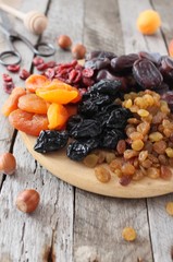 Dried apricots, dates, raisins, vintage wooden background, selective focus
