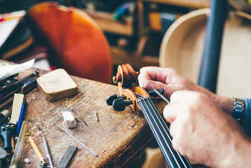 Luthier repair violin in his workshop
