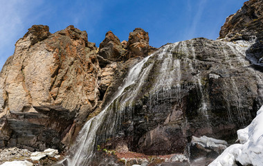 Waterfall Girlish Braids between the mountains of Northern Caucasus at early spring