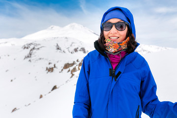 Happy Woman hiking on Mount Elbrus in sunny weather